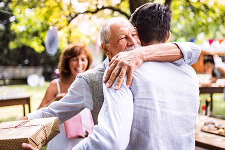 grand-père serrant dans se bras son petit-fils